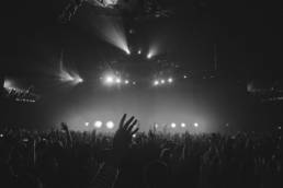 Black & white image of people dancing at a music event