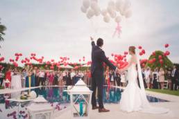 Bride & Groom on their wedding day releasing balloons