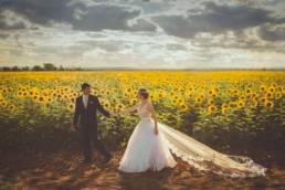 Couple on their wedding day in a field of sunflowers